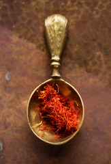 Saffron Spice. Saffron spices in a spoon. Indian spice top view. Seasonings, condiments. Cooking ingredients, flavor