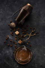 Ingredients for making coffee. Coffee pot, cup coffee with smoke and sugar tongs.