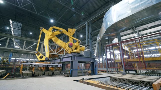 Industrial robotic arm is displacing products