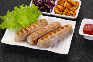 Grilled sausages served mushrooms and cabbage