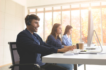 Call Center Service. Photo of customer support or sales agent.  Help line answering and telemarketing. Male caller or receptionist phone operator.Copy space for some text, advertising or slogan.