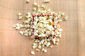 popcorn in bowl on wooden background