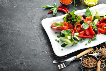 Fresh vegetables on a plate. Restaurant dishes. Top view. Free space for your text.
