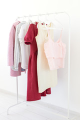 clothes, designer and Small-Sized Enterprises concept - a lot of clothes is on a hanger