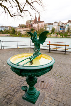 Basilisk fountain with view of Basel old Town and Rhine river, Switzerland
