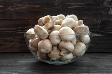 mushrooms champignon on dark wood desk