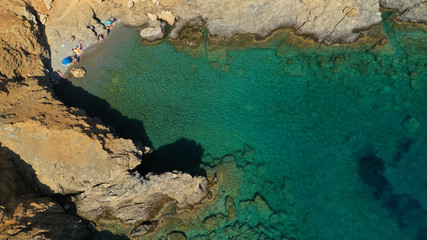 Aerial drone photo of emerald secluded crystal clear sea rocky cove of Ble limanaki or Blue Harbour in famous island of Astypalaia, Dodecanese, Greece