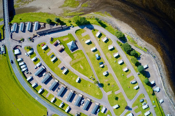 Caravan site park aerial view illuminated by summer sun at Glencoe Scotland
