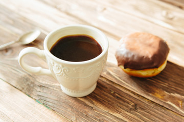 Mini donut and chocolate caramel cream and black coffee cup ,on black table tone