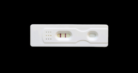 pregnancy test kit showing two lines isolated on black background