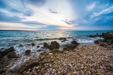 sunset on croatian stony beach