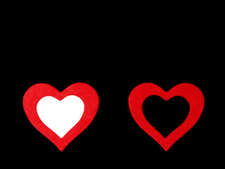 Red hearts on a black background. Winter love concept