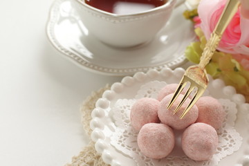 Obraz na płótnie Canvas home bakery, pink cookie ball on white dish 
