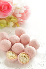 Fototapeta na wymiar home bakery, pink cookie ball on white dish 