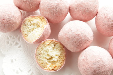 Fototapeta na wymiar home bakery, pink cookie ball on white dish 