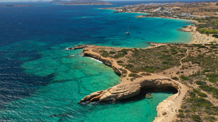 Aerial drone photo of paradise rocky seascape forming caves with turquoise clear sea near popular beaches of Pori and Italida, Koufonisi island, Cyclades, Greece