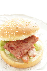 Pan fried luncheon meat and sausage in sesame bun for sandwich breakfast