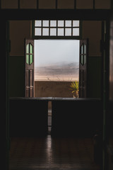 Empty room with a door to the desert 