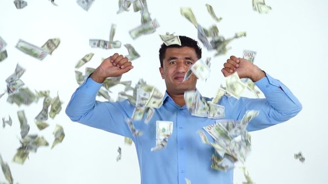 Slow motion of arab man is delighted with the fact that a lot of dollar bills are fall on him