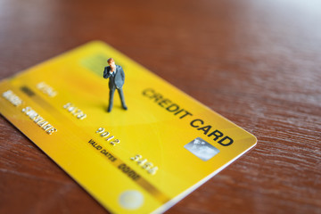 Miniature people businessmen standing on Credit Cards model using as background business concept and finance concept with copy space  for your text or  design.
