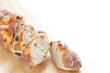 sliced raisin French bread on wooden board