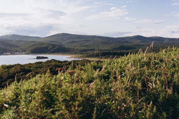 Landscape. Nature with hills,blue sky, grass and sea
