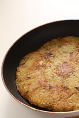 Potato pancake in frying pan