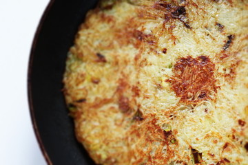 Potato pancake in frying pan