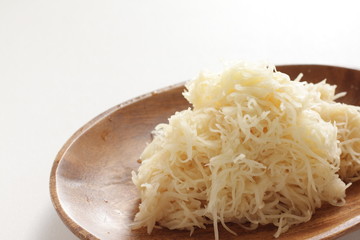 Shaved potato on wooden plate for prepared food
