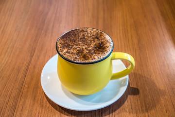 Cup of coffee on wooden table, top view. Coffee cup top view on wooden table background