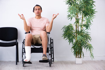 Young injured man waiting for his turn in hospital hall