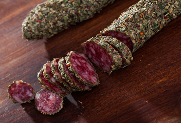 Sliced spanish sausage fuet with herbs