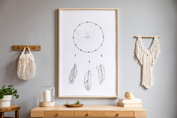 Stylish and boho concept of living room with mock up poster frame, retro chair, wooden desk, plants, macrame and elegant accessories. Modern interior design. Design home decor. Template. © FollowTheFlow