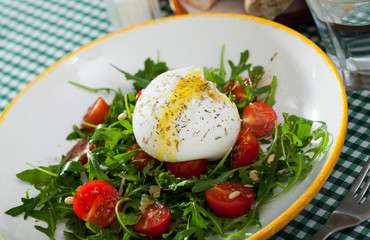Image of salad with burrata italian cheese, arugula and cherry tomatoes