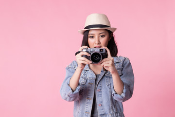 Tourist woman in summer casual clothes.Asian Smiling woman .Passenger traveling abroad to travel on pink background.She going to summer vacation.Travel trip funny with camera.