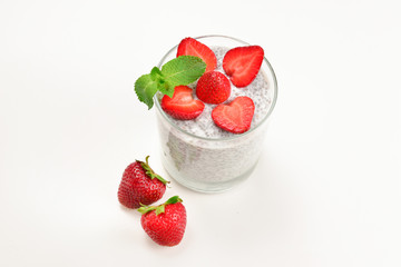Chia pudding with strawberry and mint on a white background. Space for text or design.