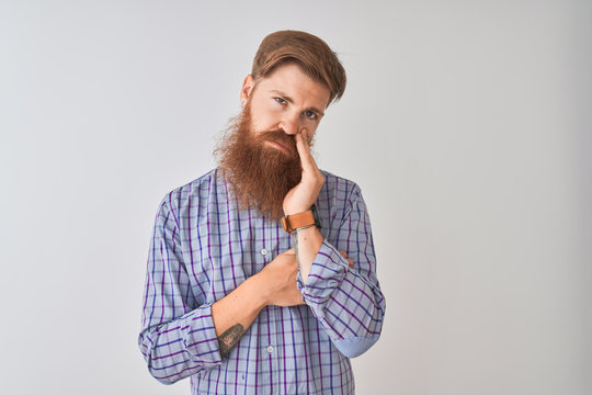 Young redhead irish man wearing casual shirt standing over isolated white background thinking looking tired and bored with depression problems with crossed arms.