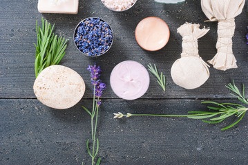 beauty product samples with fresh purple and blue dried lavenders, bath salts and massage pouches...