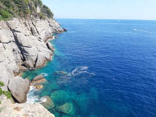 Portofino, Italy - 08/29/2019: Beautiful bay with colorful houses in Portofino in sumer days. Hiking around the ligurian mountains with amazing panoramic view.