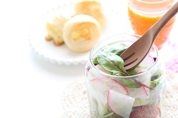 baby leaf salad in jar served with bread