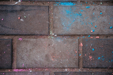crumbled colored chalk on a tile, colored dust
