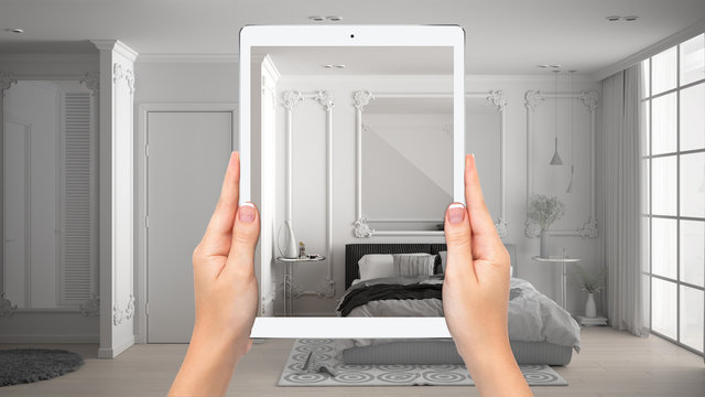 Hands holding tablet showing classic bedroom with large window, total blank project background, augmented reality concept, application to simulate furniture, interior design products