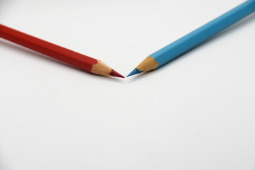 Red and blue colored pencils isolated on white background