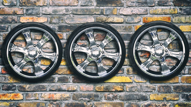 Car wheels on brick background. Copy space. Transport. Spare parts.