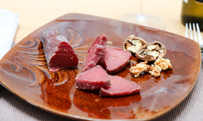 Air cured beef served with nuts and red wine