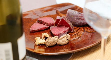 Air cured beef served with nuts and red wine