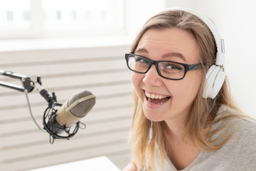 Blogger, radio host and people concept - Expressive modern DJ girl working at the radio, close-up