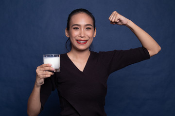 Healthy Asian woman drinking a glass of milk.