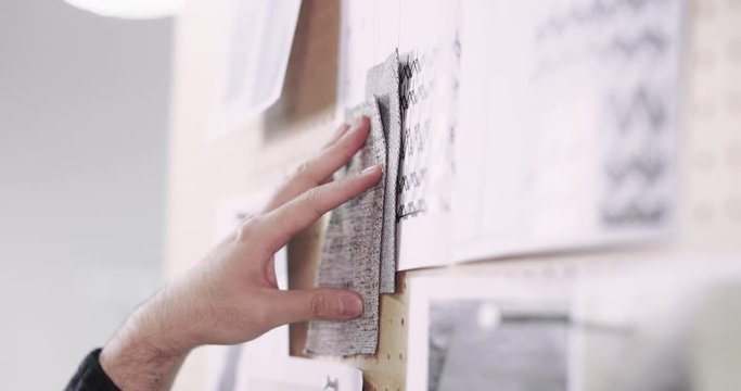 Closeup of fashion designer selecting fabrics for designs