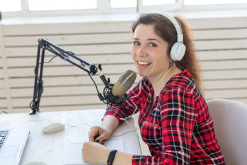 Radio, blogging, podcasting concept - close-up woman presenter on the radio